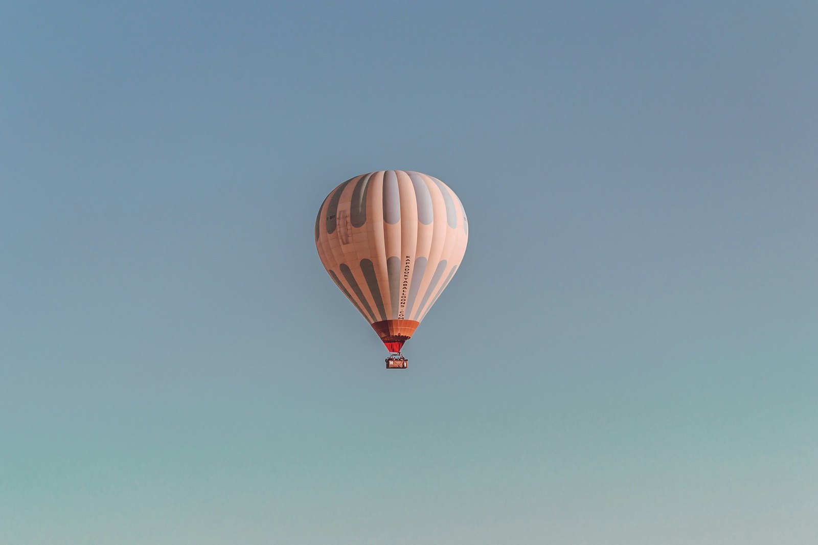 A single hot air balloon against open sky over Cappadocia